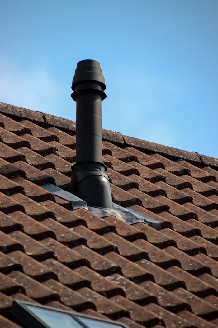 Close-up of a chimney on a tiled roof in Shaftesbury, England, showcasing architectural details.